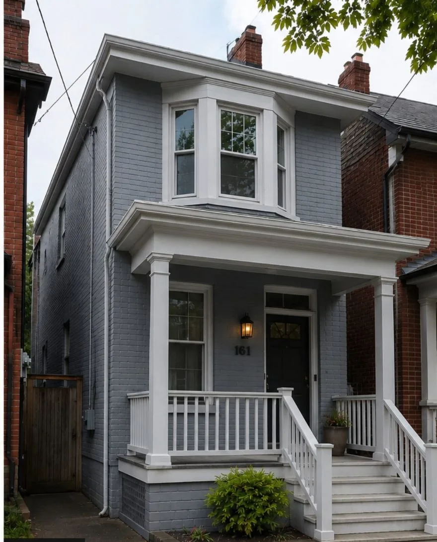 Painted brick house exterior in Toronto — Benjamin Moore Wolf Gray with white porch trim