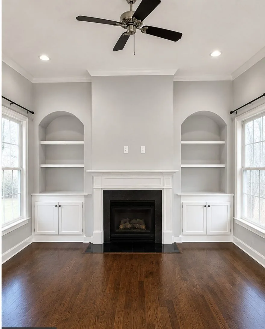 Living room built-ins and fireplace after painting — Benjamin Moore Classic Gray walls with white trim